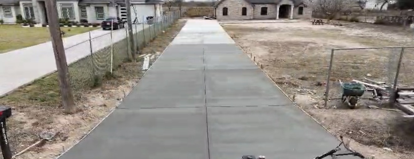 Long newly poured concrete driveway