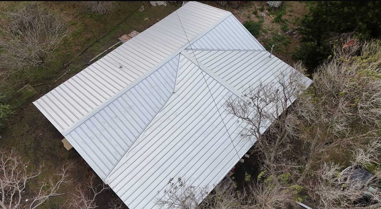 Completed light-colored residential metal roof